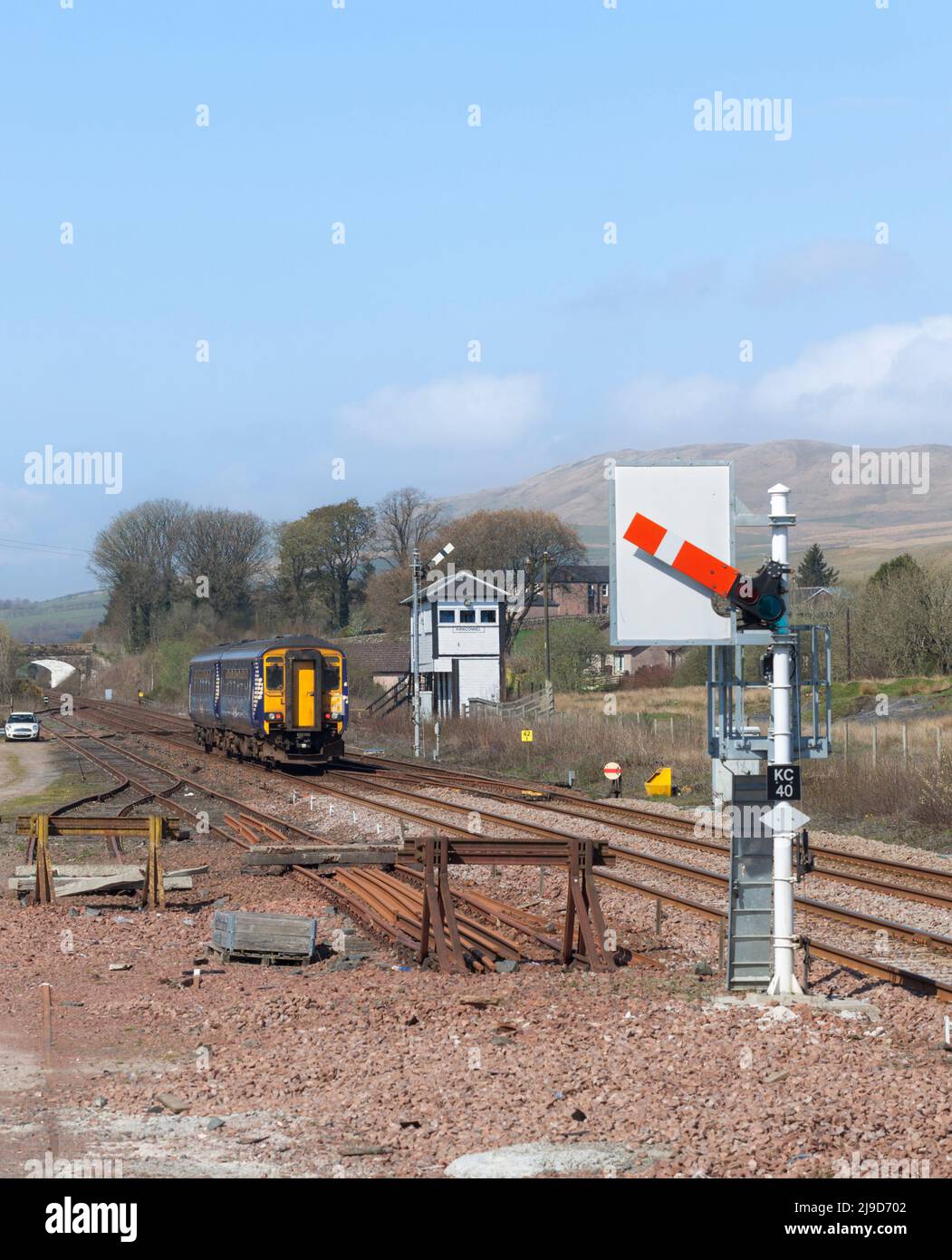 Scotrail class 156 sprinter train 156492 departing from  Kirkconnel with a mechanical signal box and semaphore railway signals Stock Photo