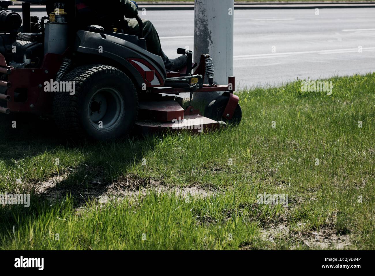 Ride-on lawnmower. concept of mowing the lawn, lawnmower cutting grass with gardening tools Stock Photo