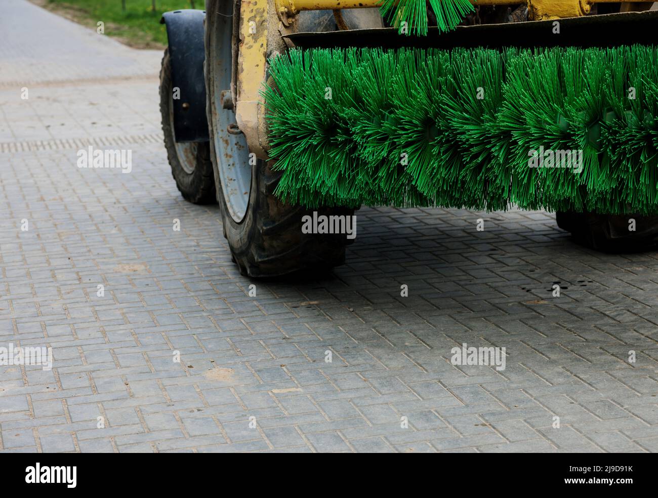 maintenance and cleaning of city streets. municipal service.  Nylon brush of the Road sweeper Stock Photo