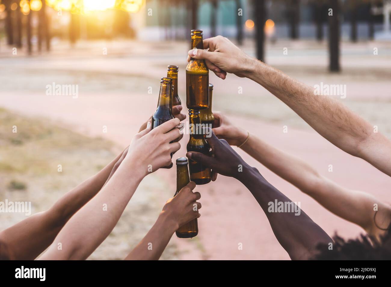 Group of friends celebrating with beer at summer party Stock Photo