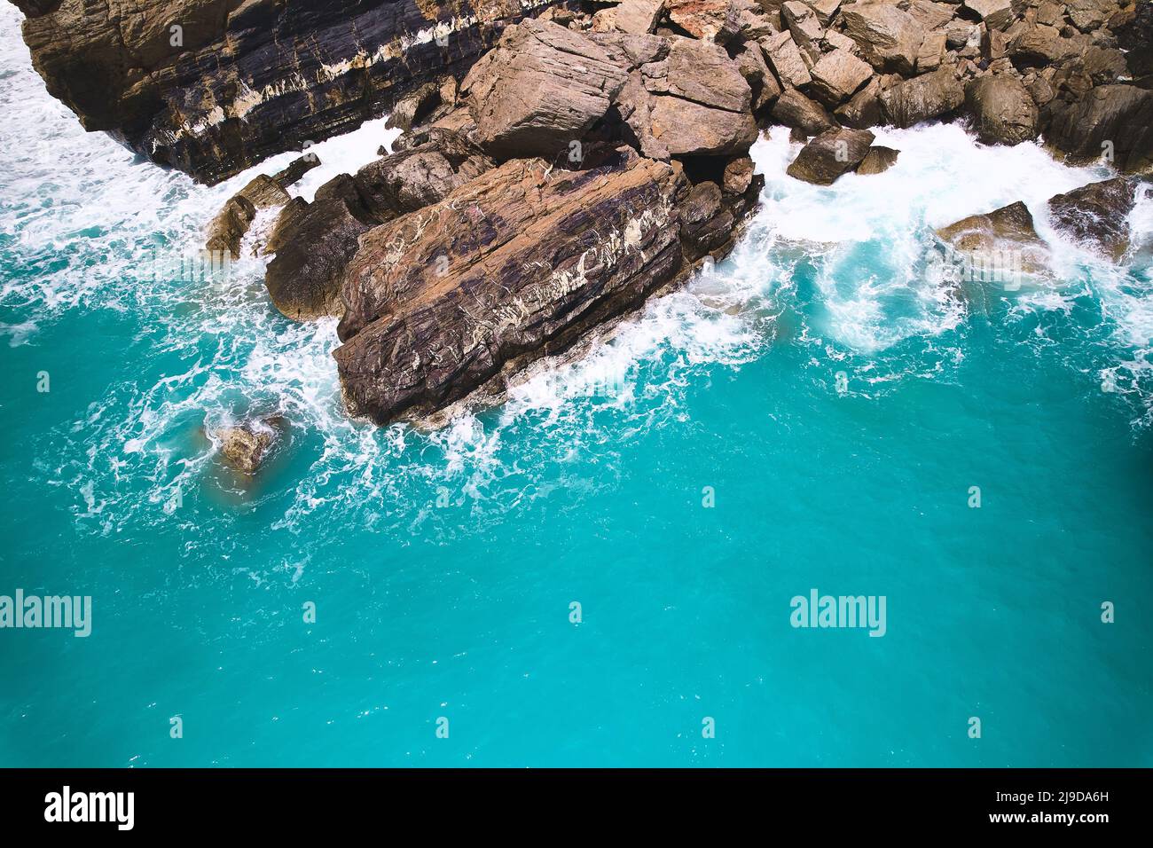 Waves break on rocks Stock Photo