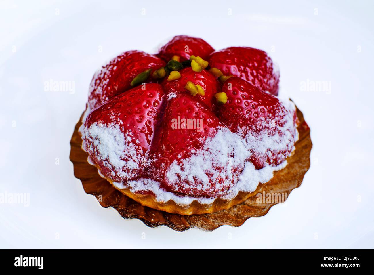 Strawberry mini tartlet dusted with powdered sugar, delicate pastry Stock Photo