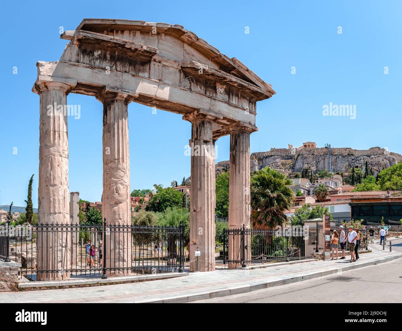 The ruins of the Gate of Athena Archegetis aka West Propylon, with the historic district of Plaka, Athens, Greece with the Acropolis in the background Stock Photo
