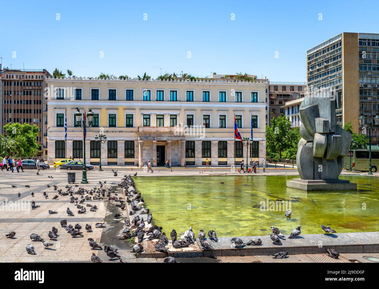 Athens, Greece - May 21 2022: The old City Hall in Athinas Street, across Kotzia Square, with lot of pigeons resting by the fountain. Stock Photo