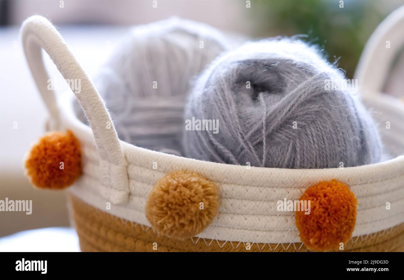 needlework still life - hand knitting tools and wool yarns on wooden table  Stock Photo - Alamy