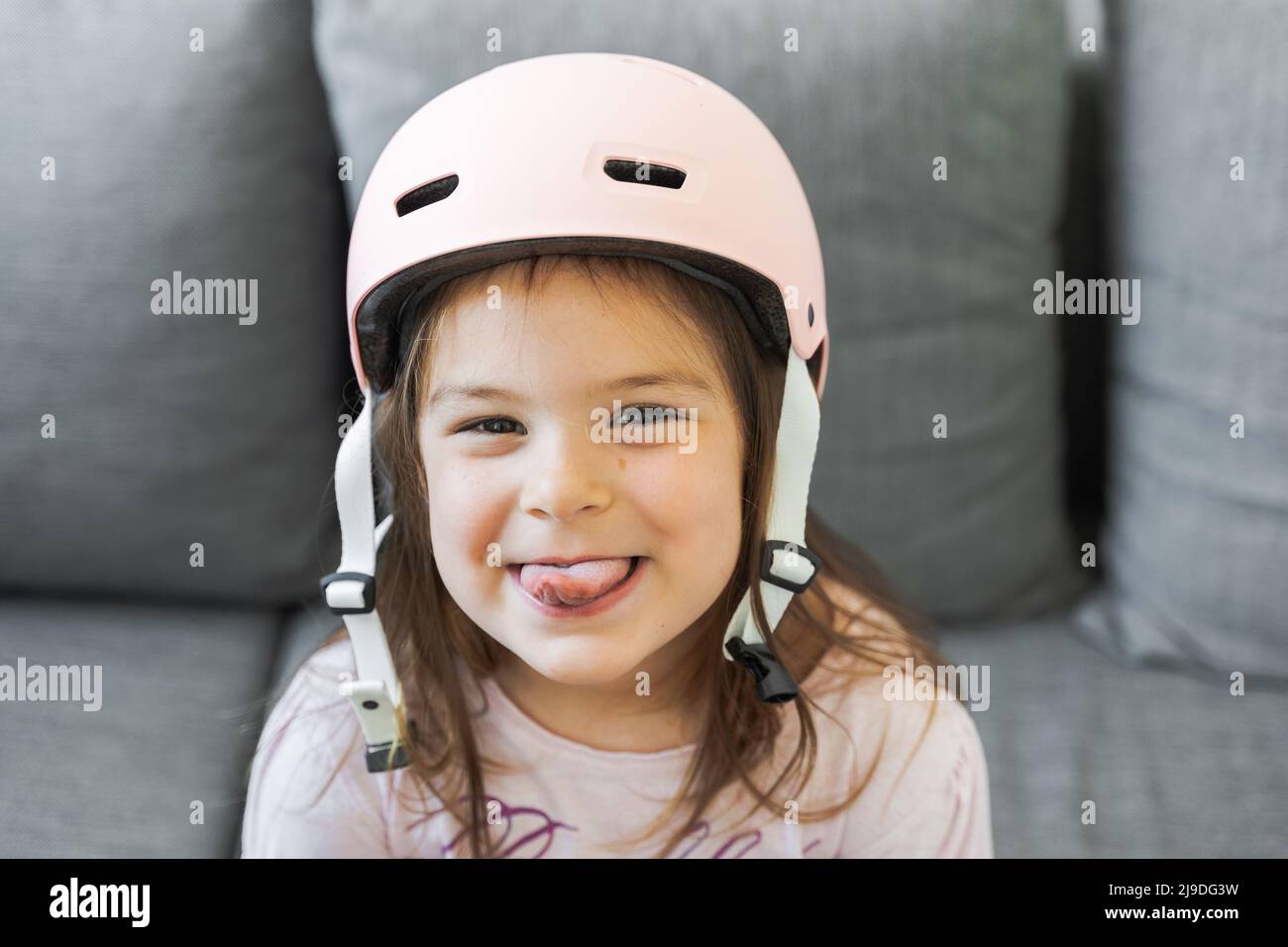 Preschool girl portrait with safety for outdoors activities. Pink