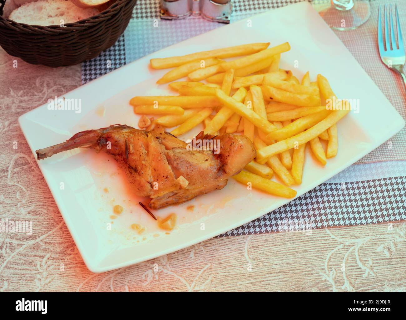 Braised rabbit served with potato garnish Stock Photo