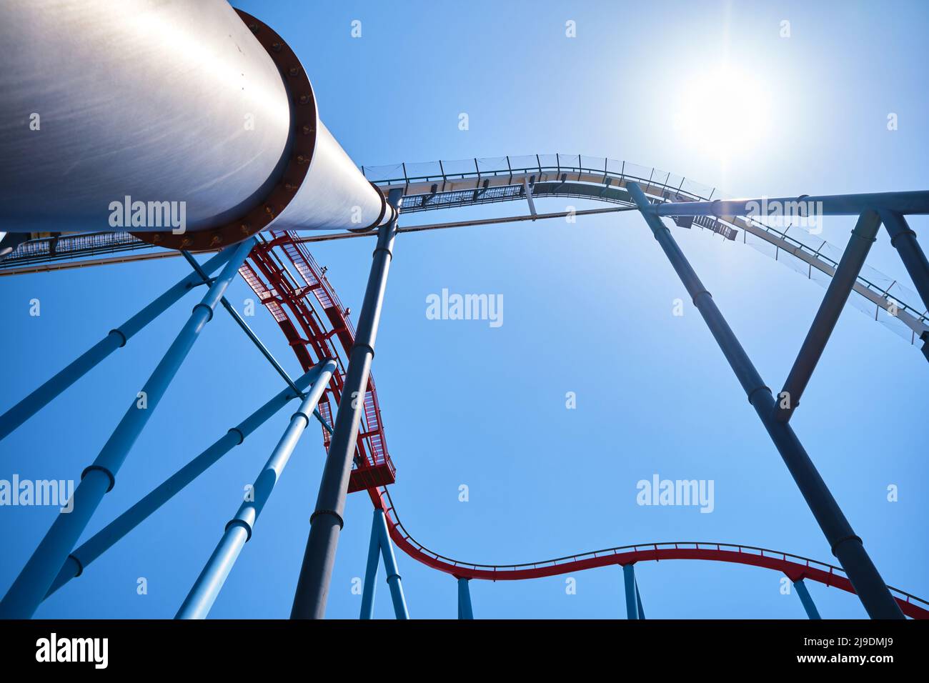 Industrial background of large vertical metal pipes against the blue ...