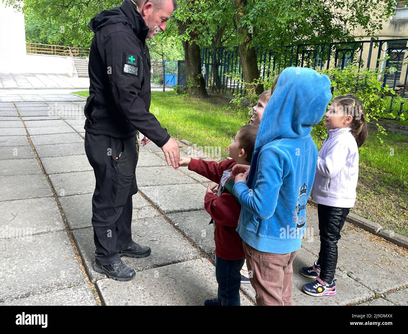 Lviv, Ukraine. 16th May, 2022. Orphans and refugee children in Ukraine greet Veterans In Aid Co-Founder Scouse Denmark from Liverpool, England, who brought a shipment of supplies and candy for them from the UK to Poland to their orphanage in Lviv on May 16, 2022. (Credit Image: © Amy Katz/ZUMA Press Wire) Stock Photo