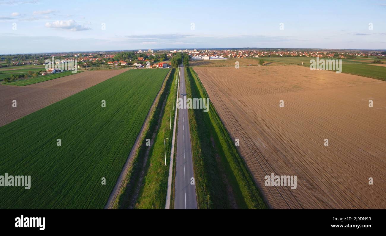 Aerial photography of road and arable crop land for wheat sunflower or corn in Serbia Stock Photo