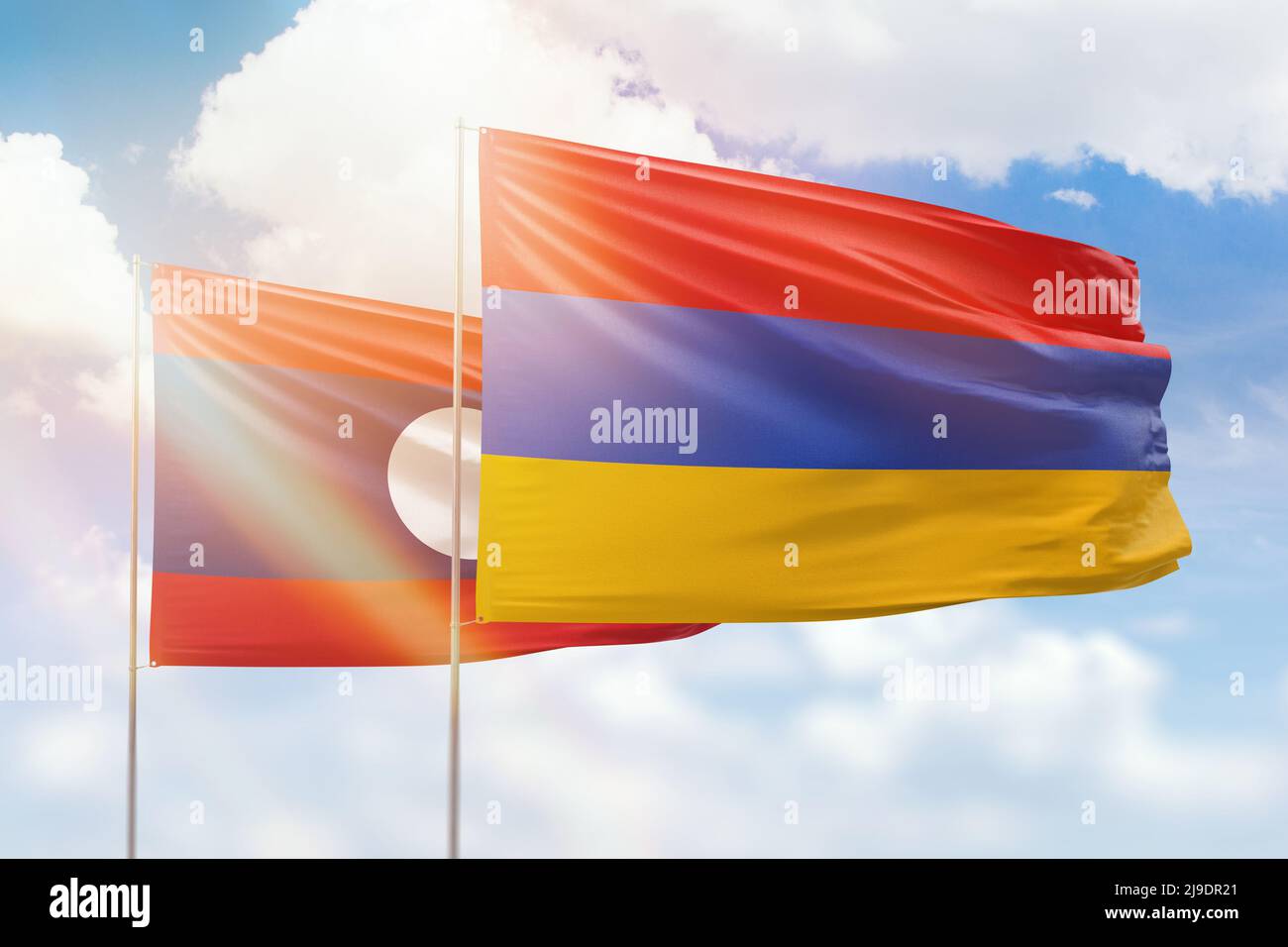 Sunny blue sky and flags of armenia and laos Stock Photo - Alamy