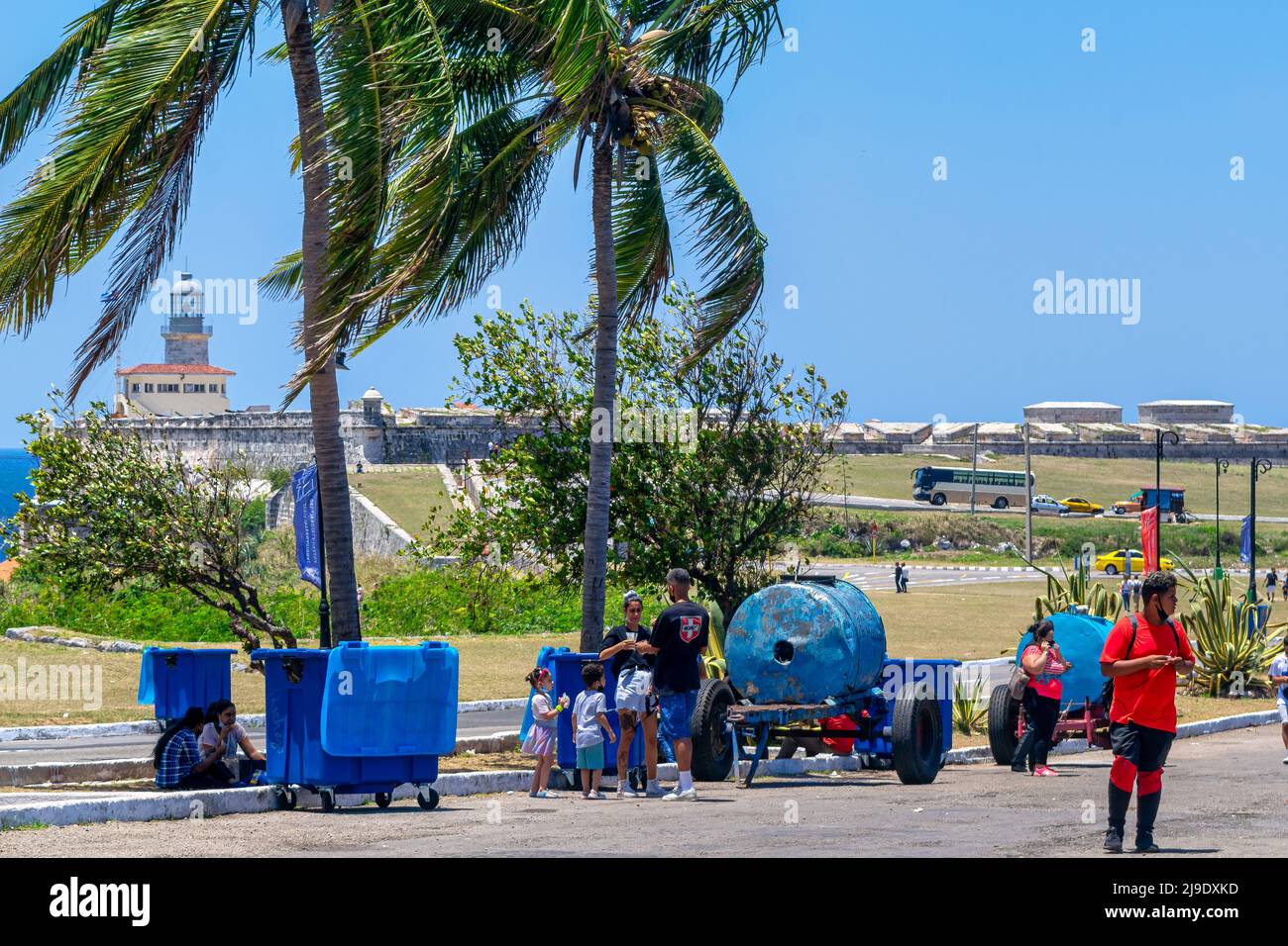 Cuban people by a cart with a storage tank in Fortaleza de San Carlos