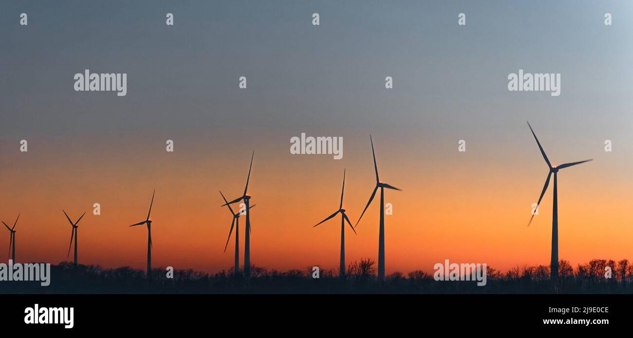 Wind Turbines In Rural Landscape At Sunset. Green renewable and ...