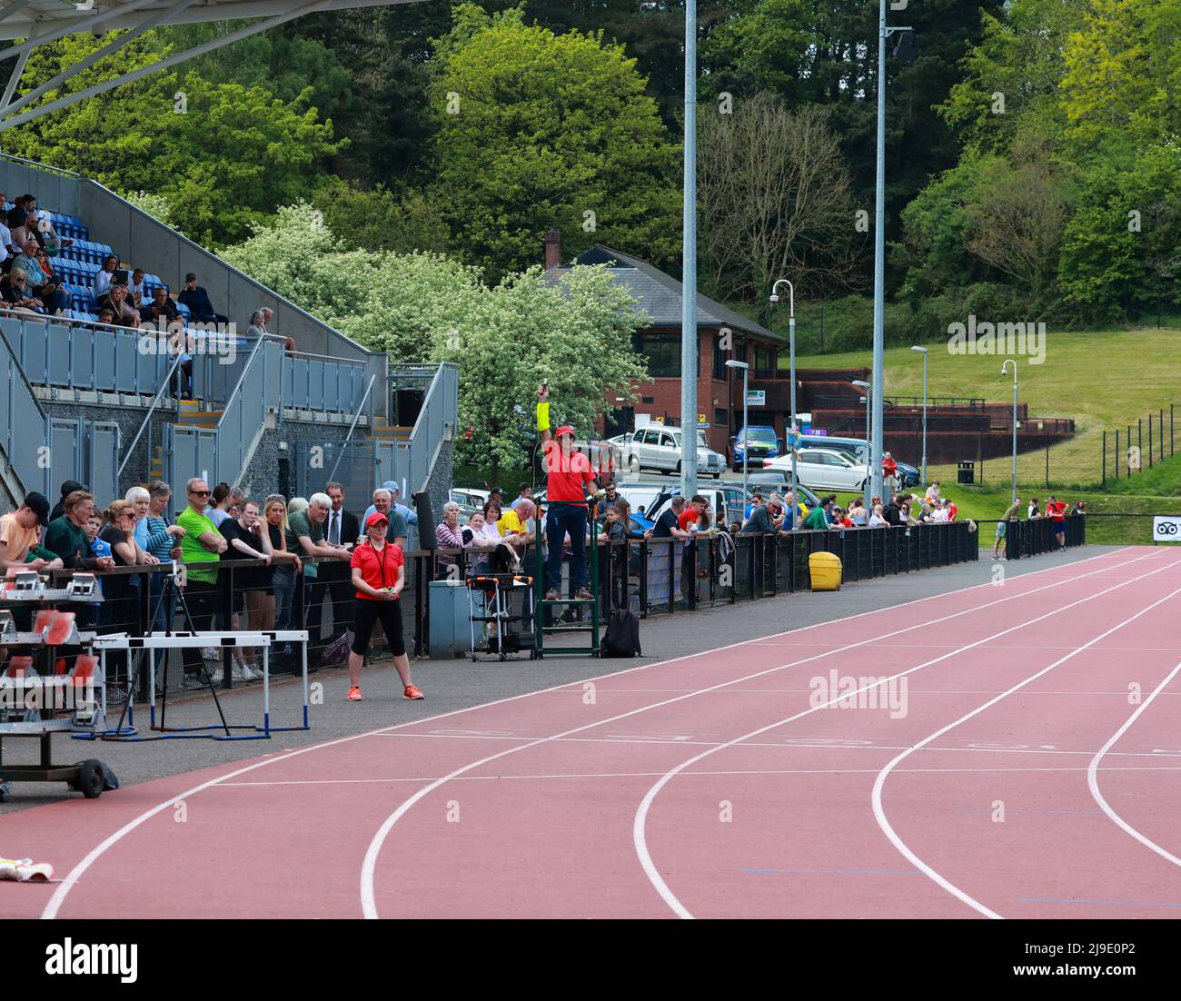 Athletics track, race official starting race at the Mary Peters Track
