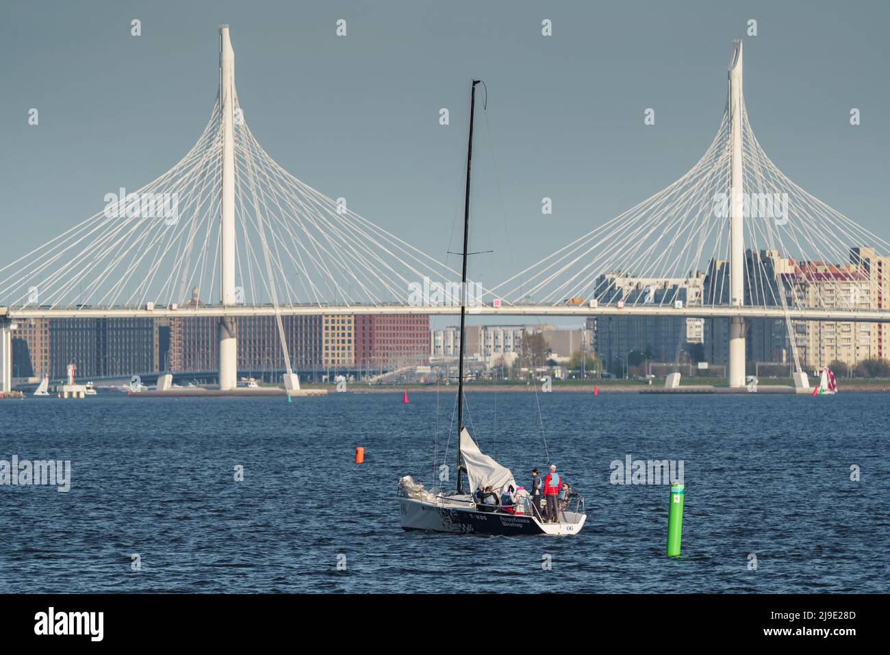 Russia, St. Petersburg, 20 May 2022: Sailing boats in the background of the new cable stayed bridge in sunset light Stock Photo
