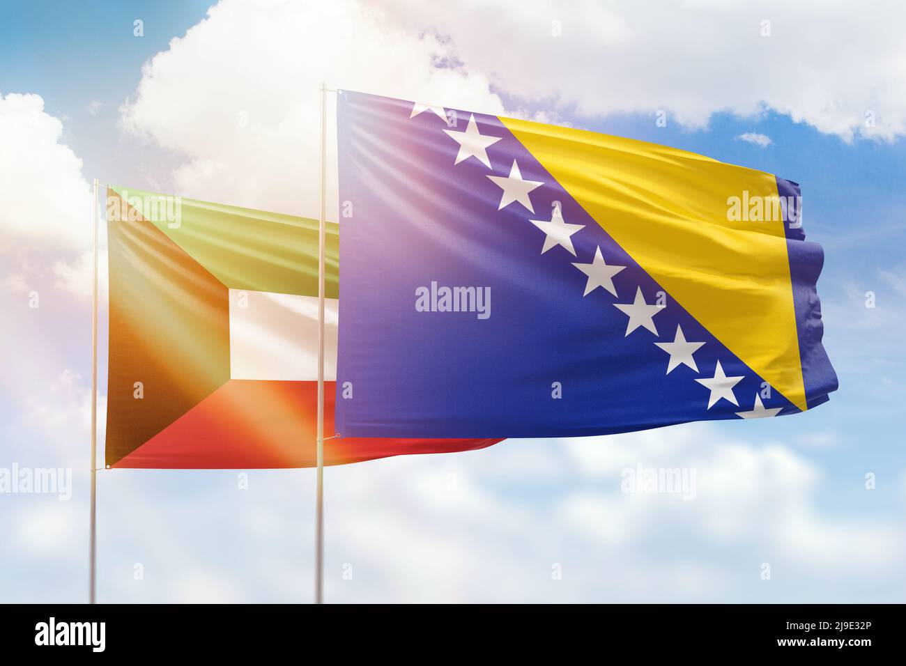 Sunny blue sky and flags of bosnia and kuwait Stock Photo - Alamy