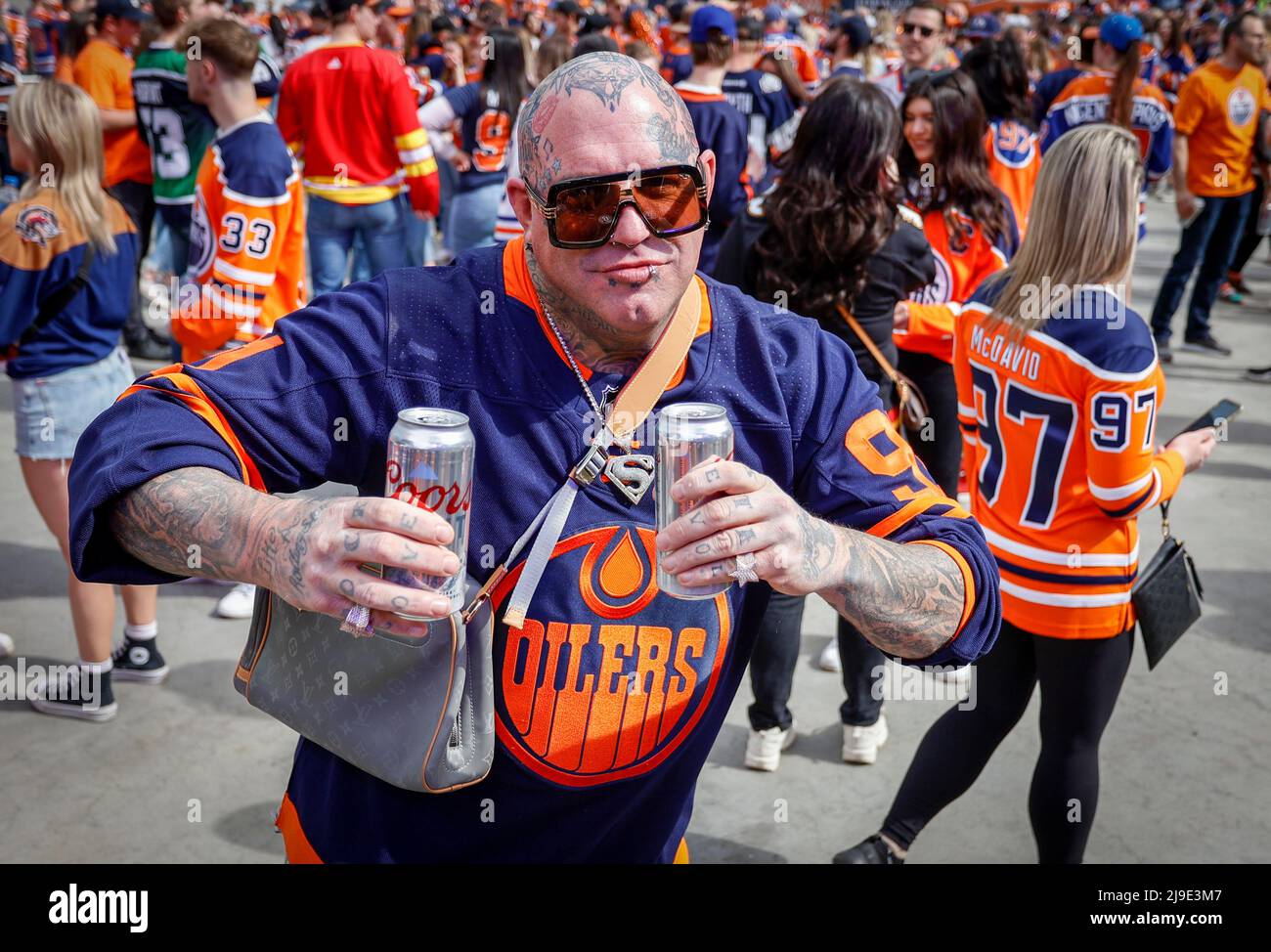 Edmonton Oilers fan Ally Gylander, right, and Calgary Flames fan Julian  Adams, centre, show their team spirit at a fan fest prior to NHL  second-round playoff hockey action in Edmonton, Sunday, May