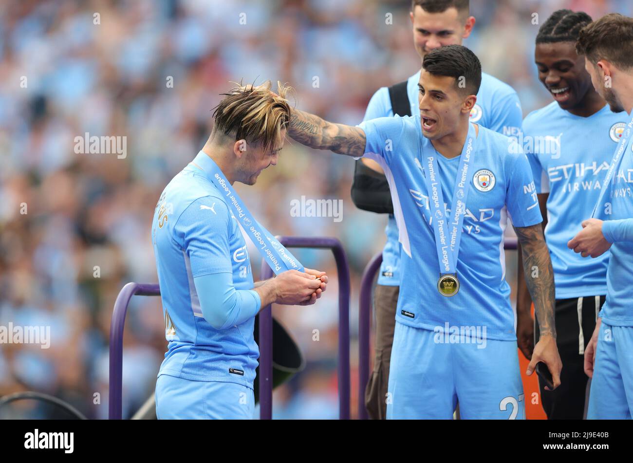 (220523) -- MANCHESTER, May 23, 2022 (Xinhua) -- Jack Grealish (L) and Joao Cancelo of Manchester City celebrate winning the Premier League after beating Aston Villa during their English Premier League match in Manchester, Britain, May 22, 2022. (Xinhua)FOR EDITORIAL USE ONLY. NOT FOR SALE FOR MARKETING OR ADVERTISING CAMPAIGNS. NO USE WITH UNAUTHORIZED AUDIO, VIDEO, DATA, FIXTURE LISTS, CLUB/LEAGUE LOGOS OR 'LIVE' SERVICES. ONLINE IN-MATCH USE LIMITED TO 45 IMAGES, NO VIDEO EMULATION. NO USE IN BETTING, GAMES OR SINGLE CLUB/LEAGUE/PLAYER PUBLICATIONS. Stock Photo