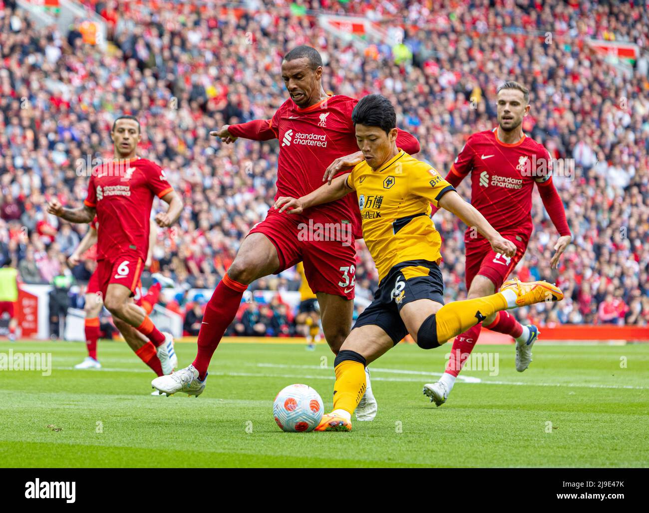 (220523) -- LIVERPOOL, May 23, 2022 (Xinhua) -- Liverpool's Joel Matip (L, front) vies with Wolverhampton Wanderers' Hwang Hee-chan (R, front) during the English Premier League match between Liverpool and Wolverhampton Wanderers in Liverpool, Britain, on May 22, 2022. (Xinhua) FOR EDITORIAL USE ONLY. NOT FOR SALE FOR MARKETING OR ADVERTISING CAMPAIGNS. NO USE WITH UNAUTHORIZED AUDIO, VIDEO, DATA, FIXTURE LISTS, CLUB/LEAGUE LOGOS OR 'LIVE' SERVICES. ONLINE IN-MATCH USE LIMITED TO 45 IMAGES, NO VIDEO EMULATION. NO USE IN BETTING, GAMES OR SINGLE CLUB/LEAGUE/PLAYER PUBLICATIONS. Stock Photo