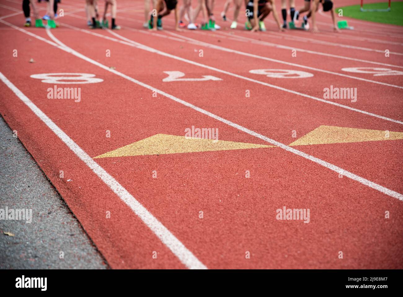 Runners at the starting blocks on an athletic racing track Stock Photo
