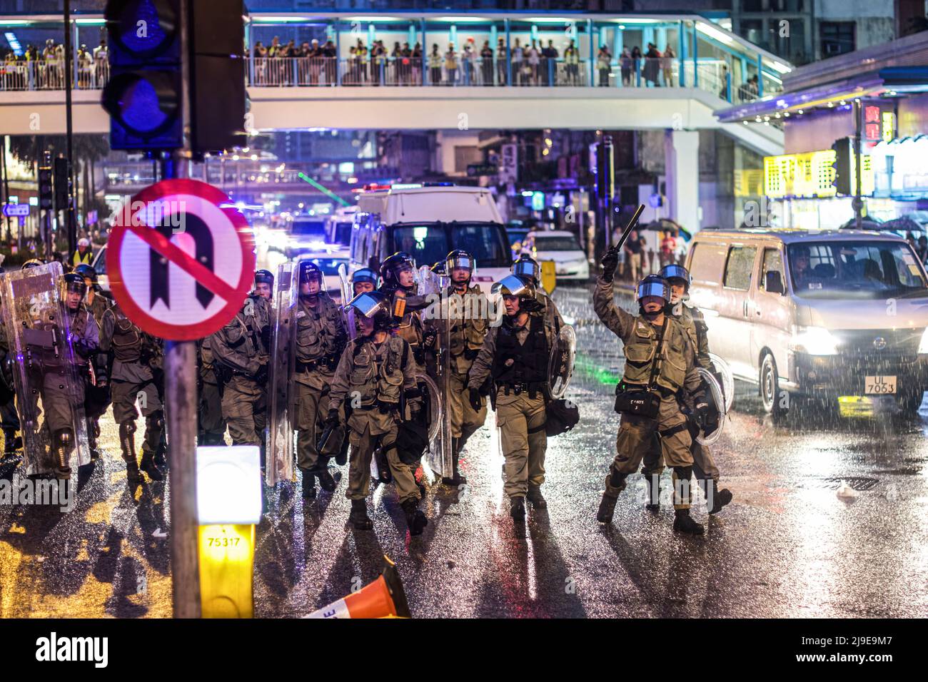Police officers in riot gear disembarking their vehicles with shields ...