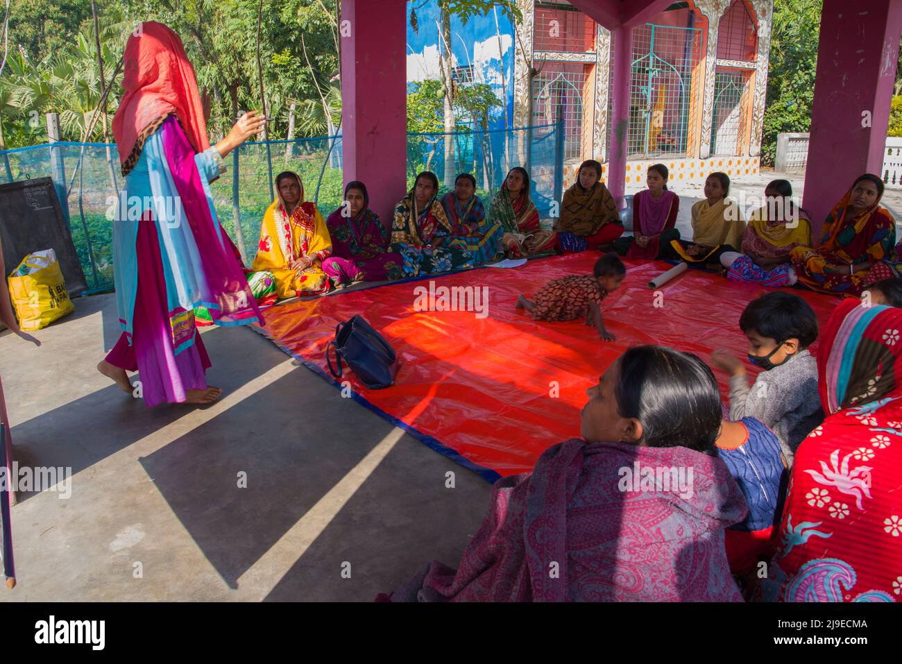 Local NGO workers conducting a courtyard meeting to train rural women on nutrition, hygiene and gender in Satkhira district of southern Bangladesh Stock Photo