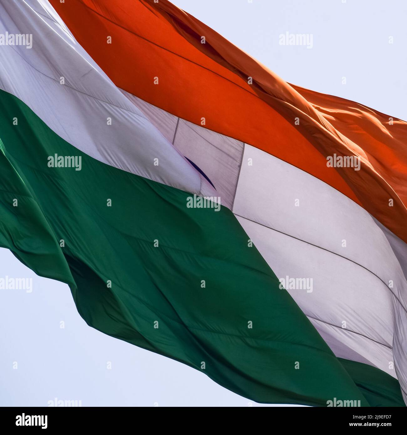 India flag flying high at Connaught Place with pride in blue sky, India flag fluttering, Indian Flag on Independence Day and Republic Day of India, ti Stock Photo