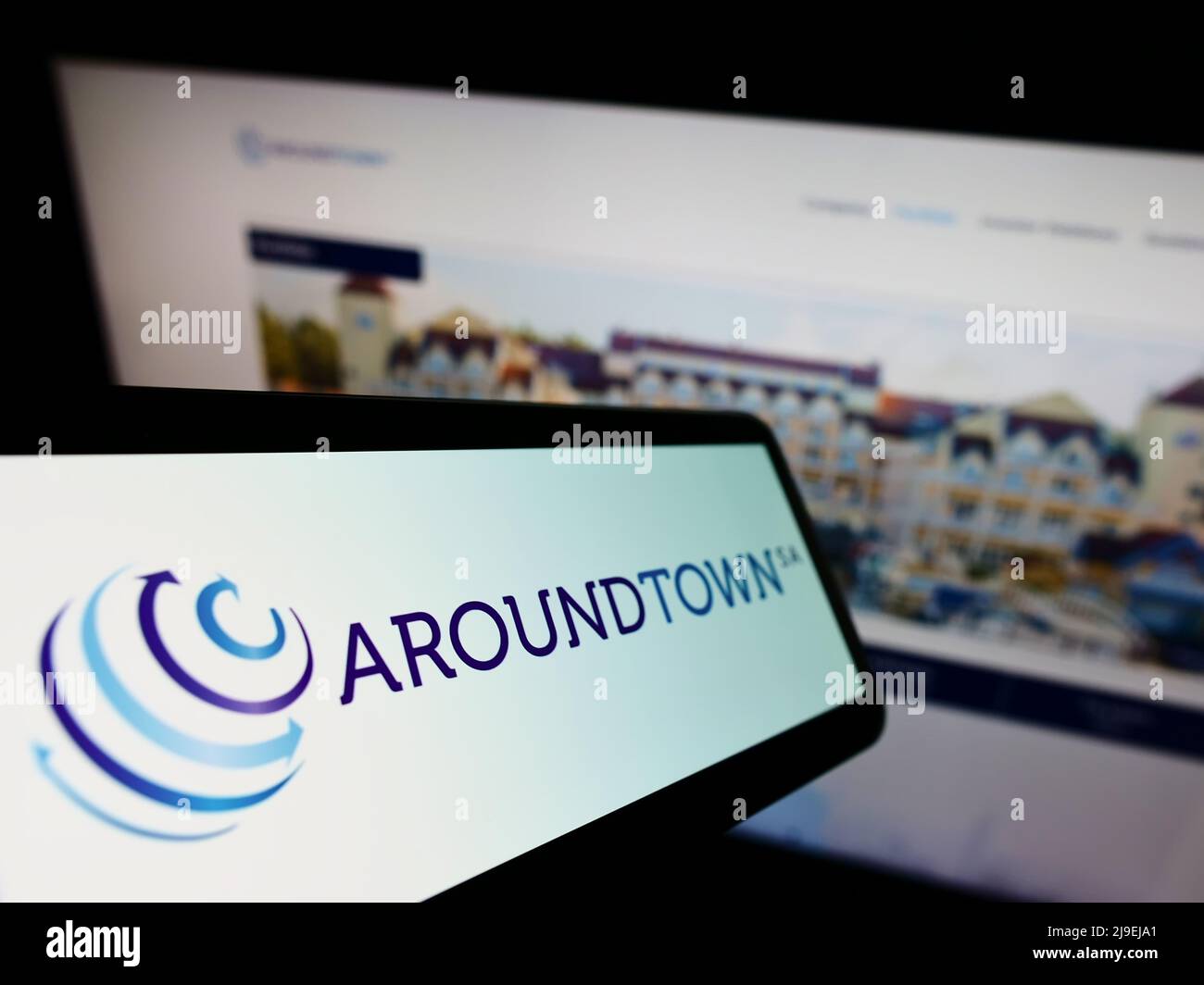 Cellphone with logo of real estate company Aroundtown SA on screen in front of business website. Focus on center of phone display. Stock Photo