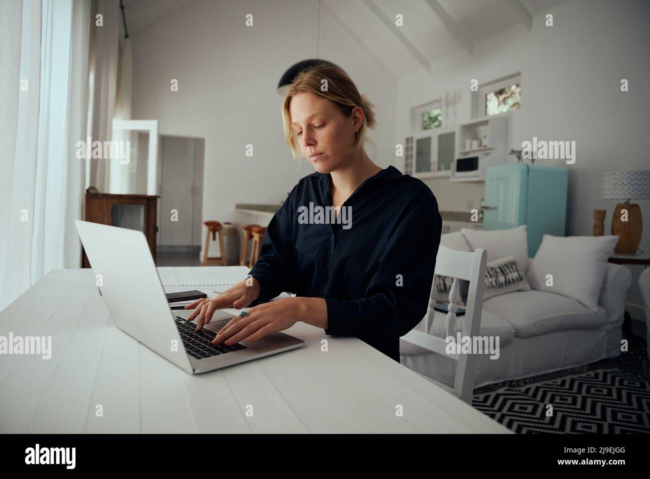 Caucasian female business woman typing on laptop working in home workspace Stock Photo