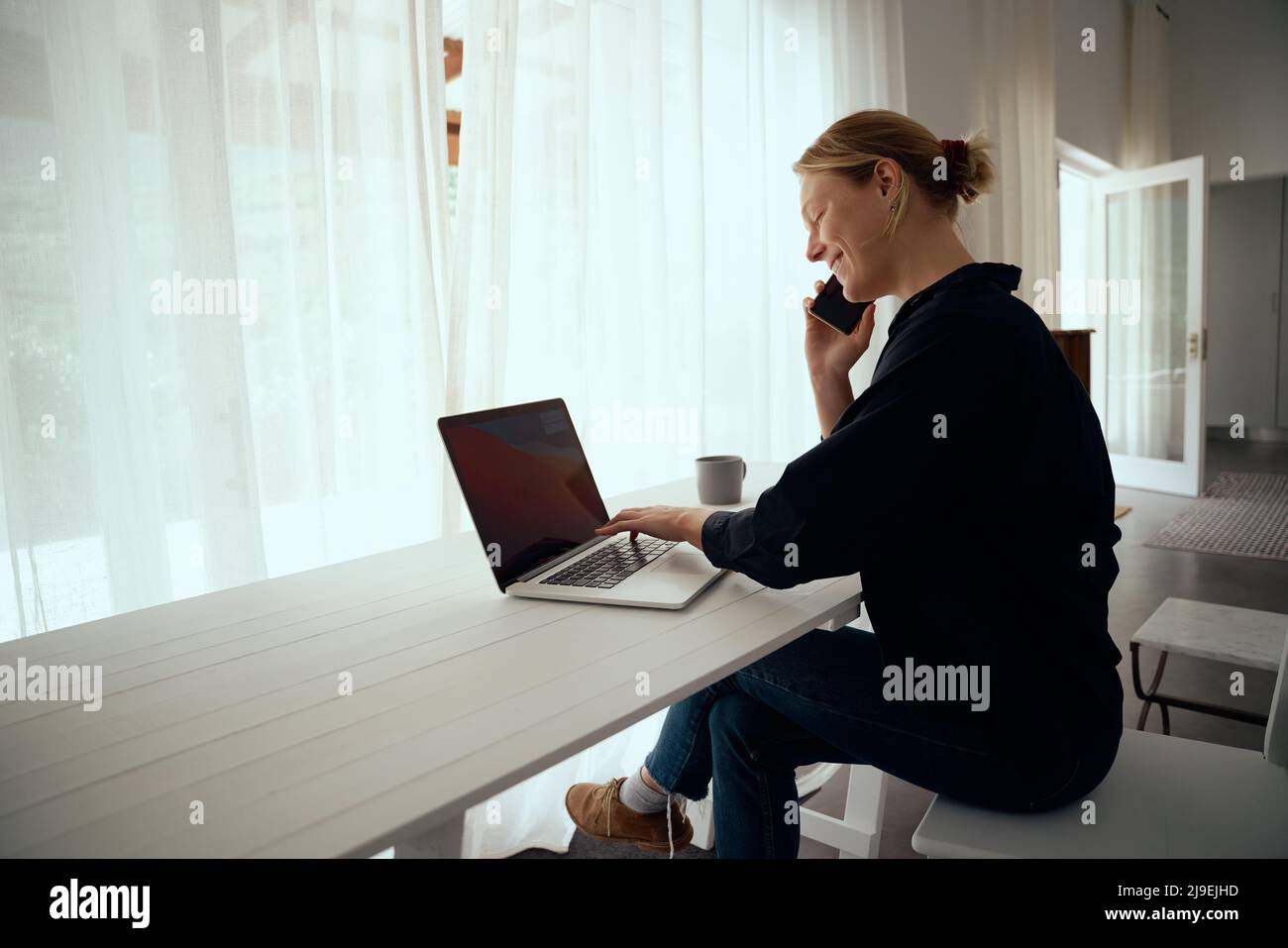 Caucasian female working from home engaging in business call sitting  Stock Photo