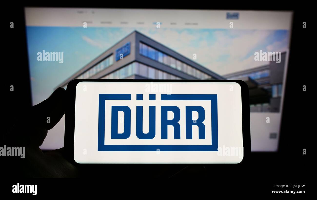 Logo of public company Dürr AG displayed on a smartphone. Flag of Germany  background. Credit: PIXDUCE Stock Photo - Alamy, image size:1300x821