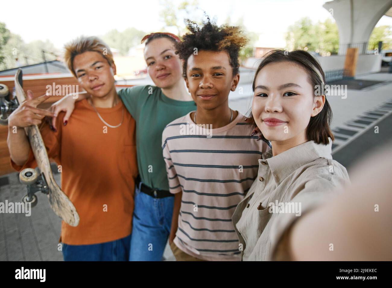 POV shot of diverse group of teens taking selfie photo outdoors in ...