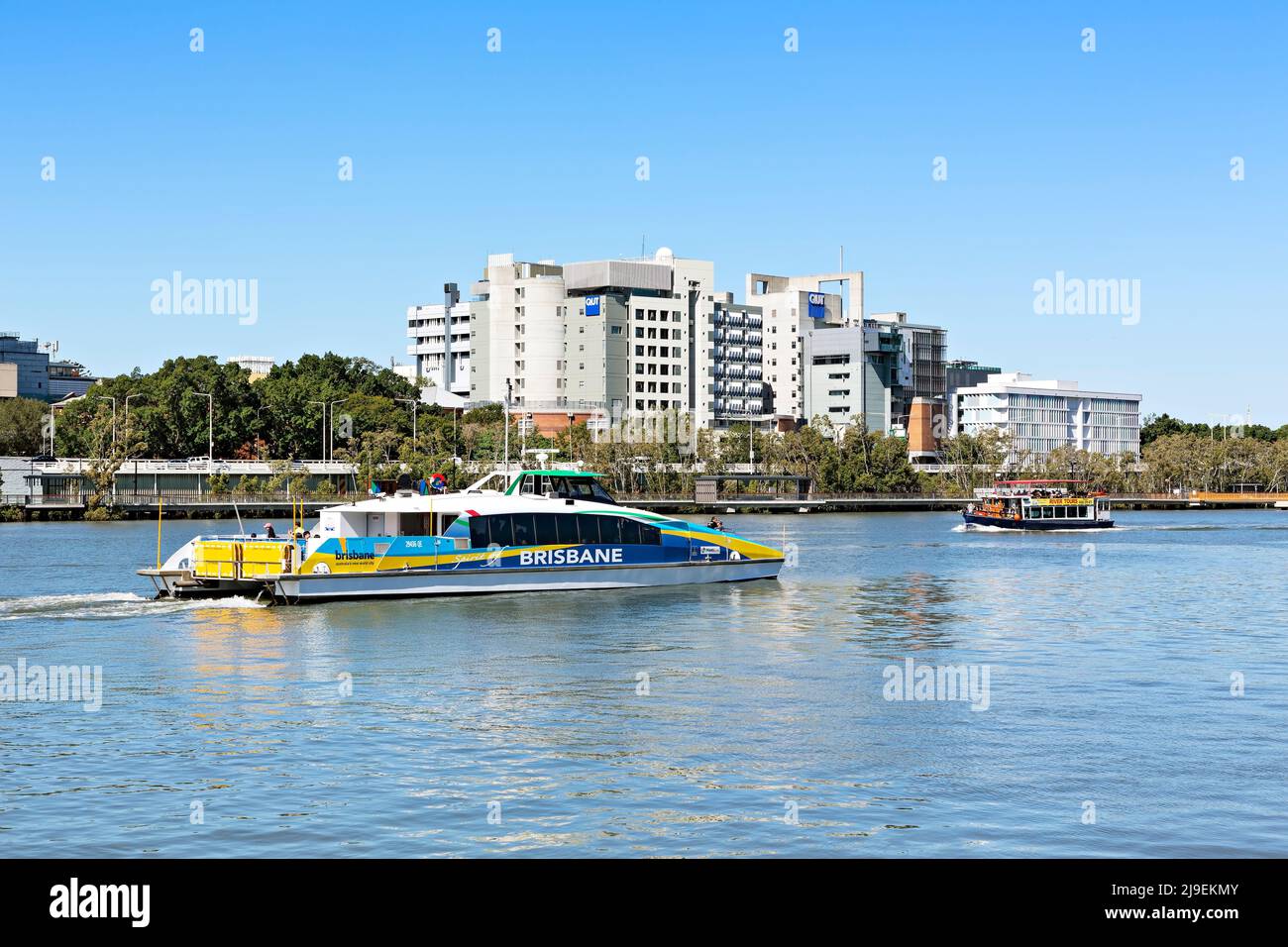 Brisbane Australia /  A fast CityCat Ferry carries passengers along the Brisbane River. Stock Photo