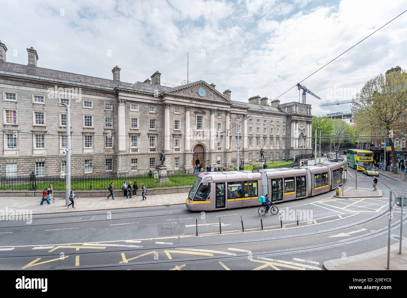 The Luas tram passes in front of Trinity College Dublin at College Green, Dublin , Ireland Stock Photo
