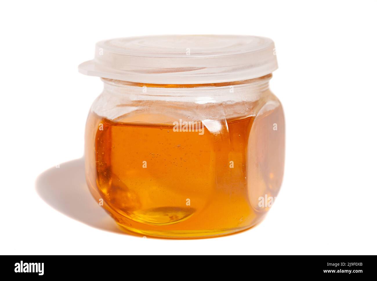 glass honey jar isolated on white background Stock Photo - Alamy