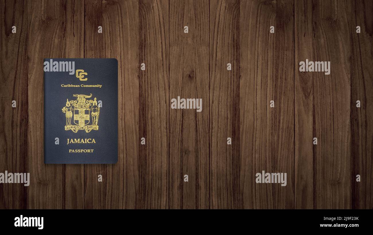 Jamaican passport on a wooden background ,The Jamaican passport is issued to citizens of Jamaica for international travel Stock Photo