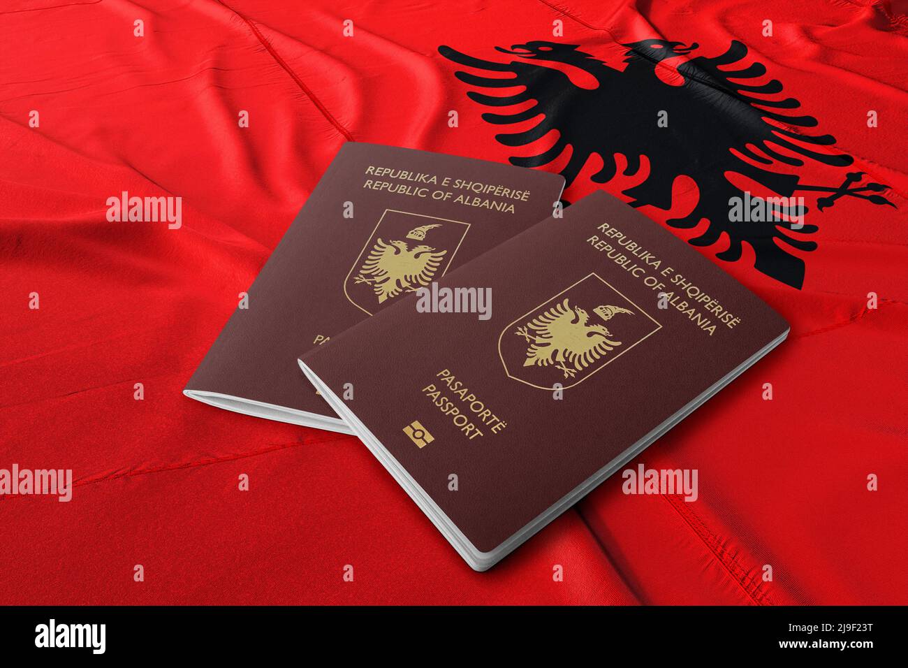 Albanian passport on its flag, The Albanian passport is a travel document issued by the Ministry of Interior to Albanian citizens Stock Photo