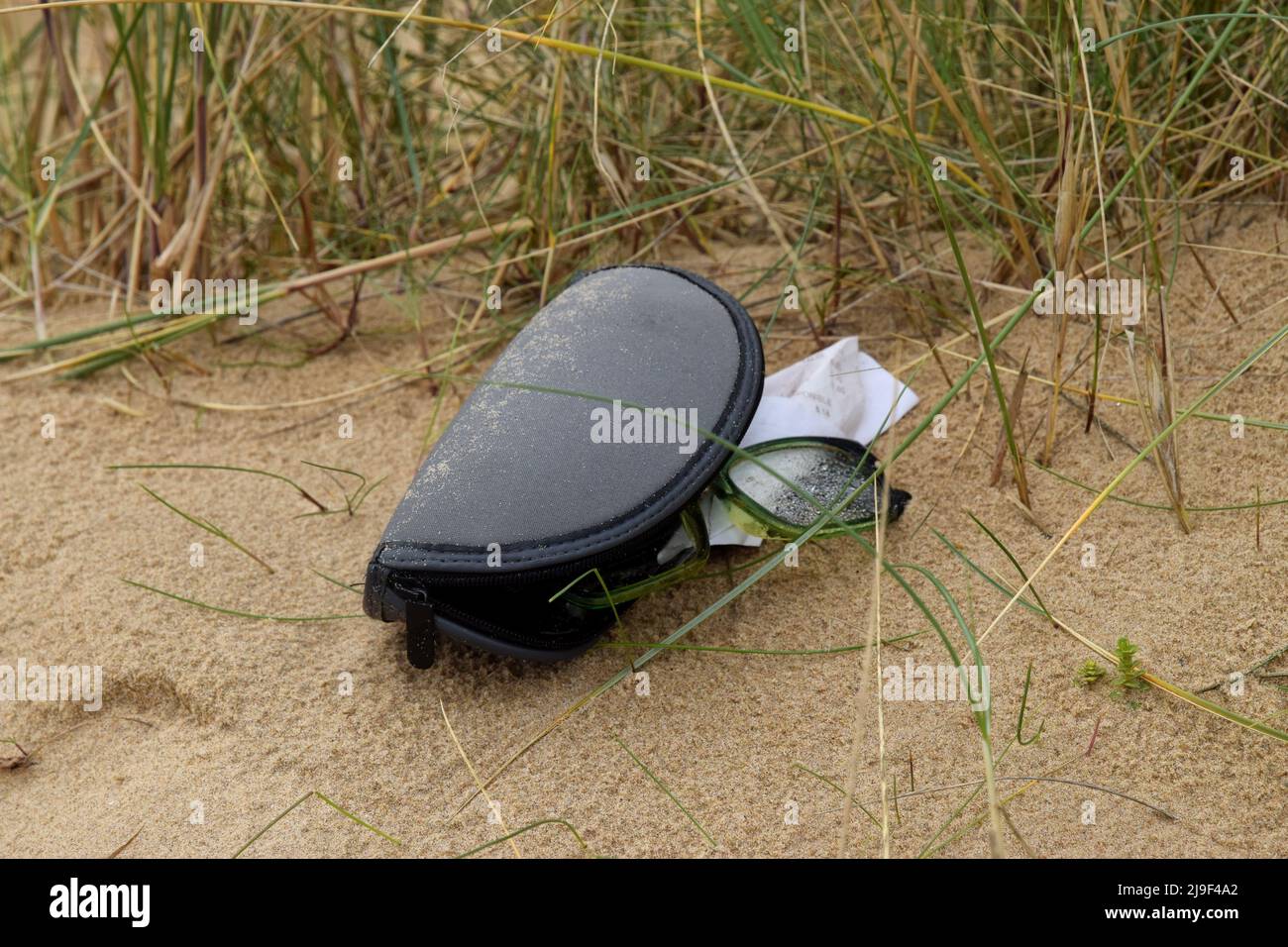 glasses in case dropped on beach,england Stock Photo Alamy