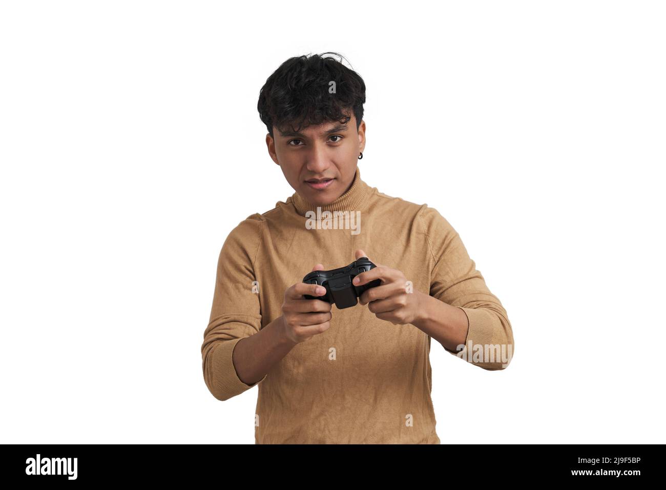 Young peruvian man playing video games with a joystick, isolated. Stock Photo