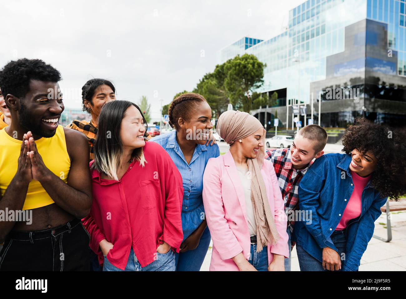 Young diverse people having fun outdoor laughing together - Focus on ...