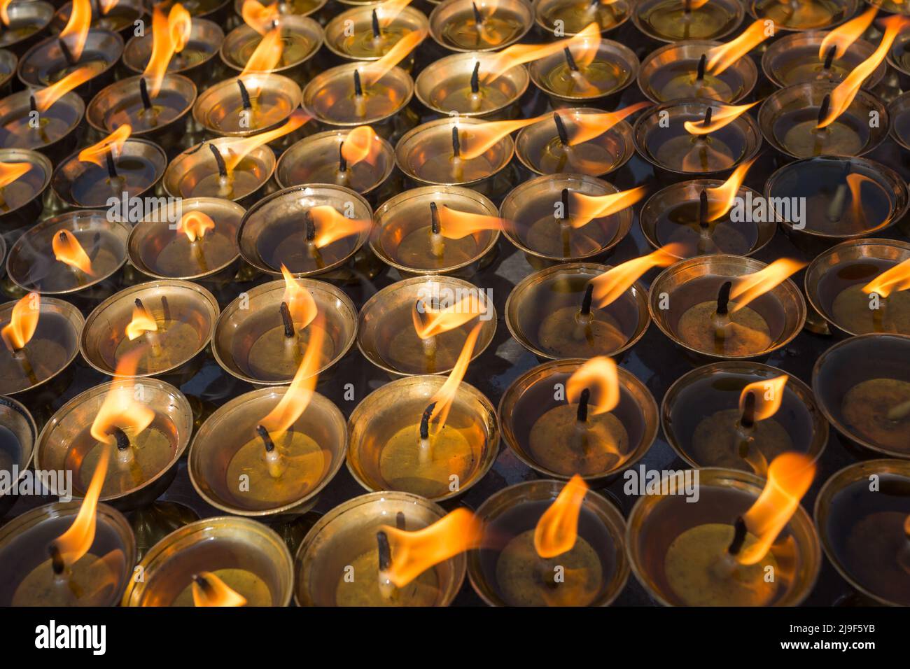 Burning prayer candles in buddhist temple Stock Photo Alamy