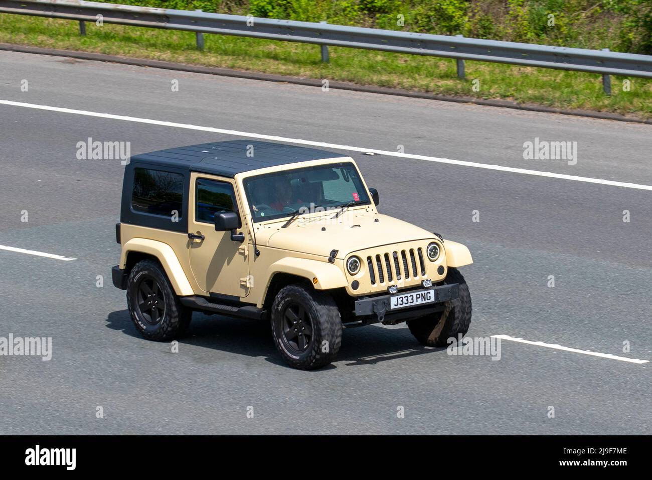 2007 beige Jeep Wrangler Sahara Sport CRD 175 Auto Soft Top 2777cc Diesel  4x4 SUV; driving on the M61 Motorway, Manchester, UK Stock Photo - Alamy