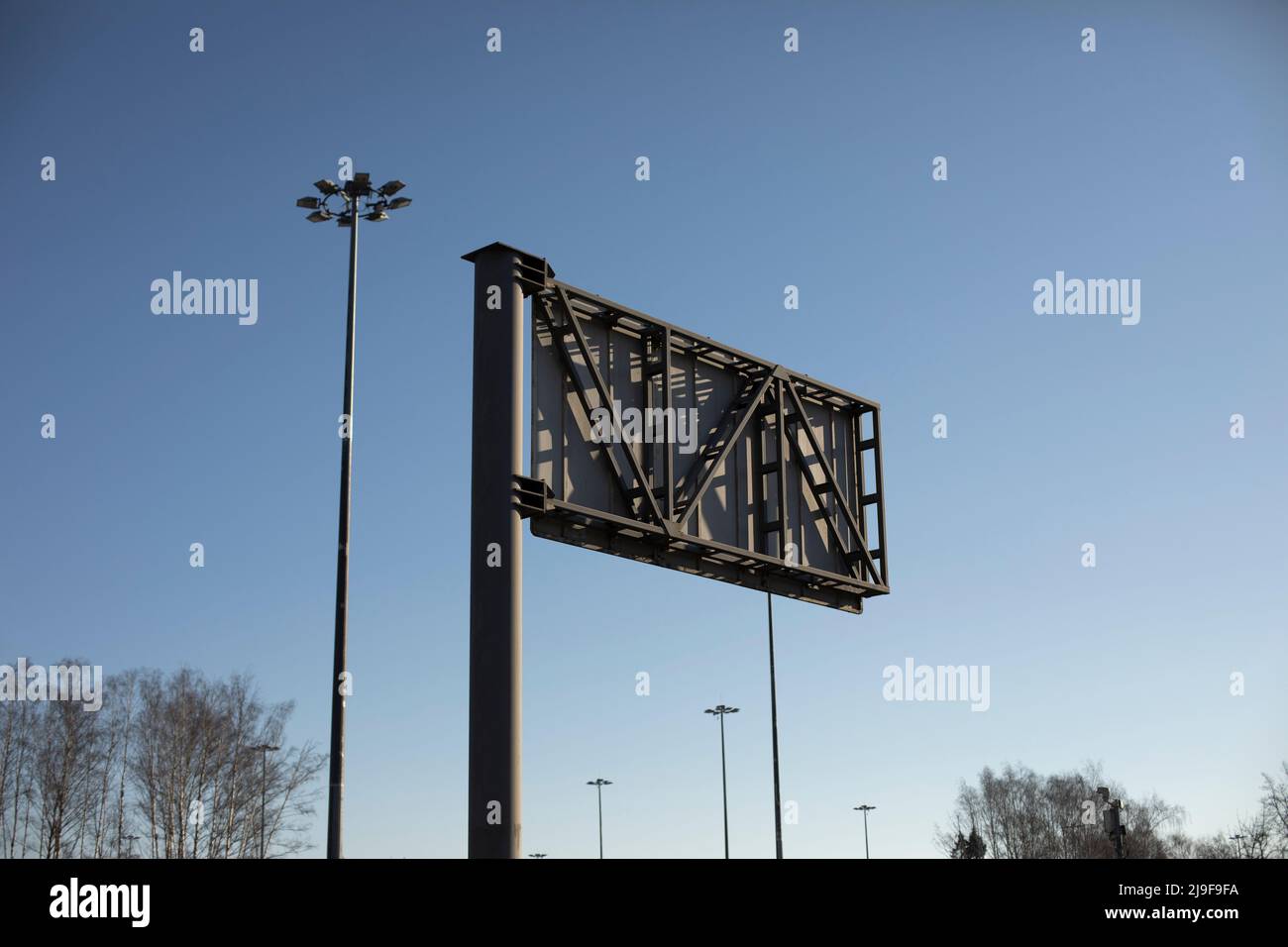 Billboard on road. Design for installation of advertising. Pole on track. Stock Photo