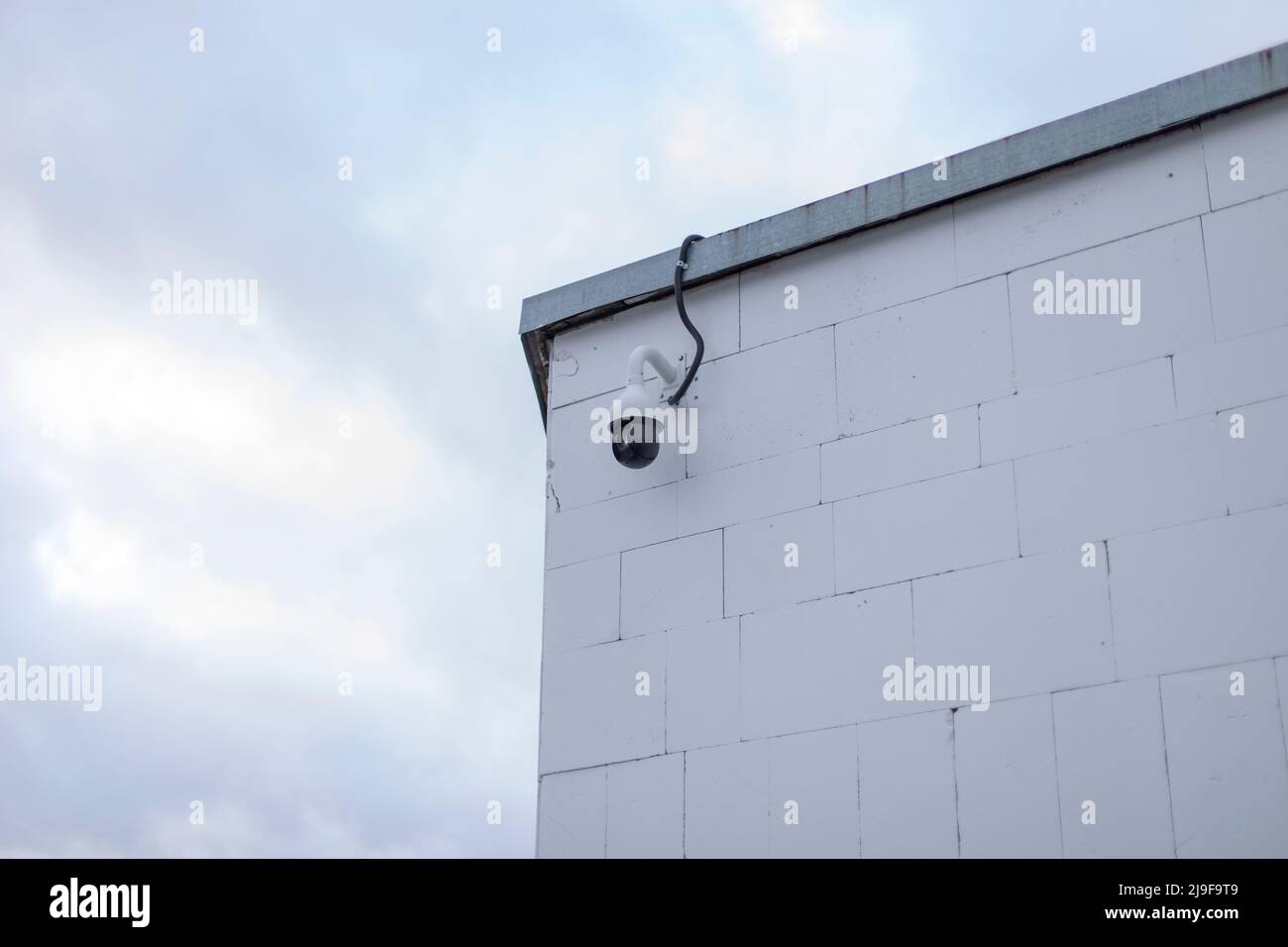 Video camera on corner of building. Video surveillance system. Security camera. Equipment for shooting street. Image capture system. Stock Photo