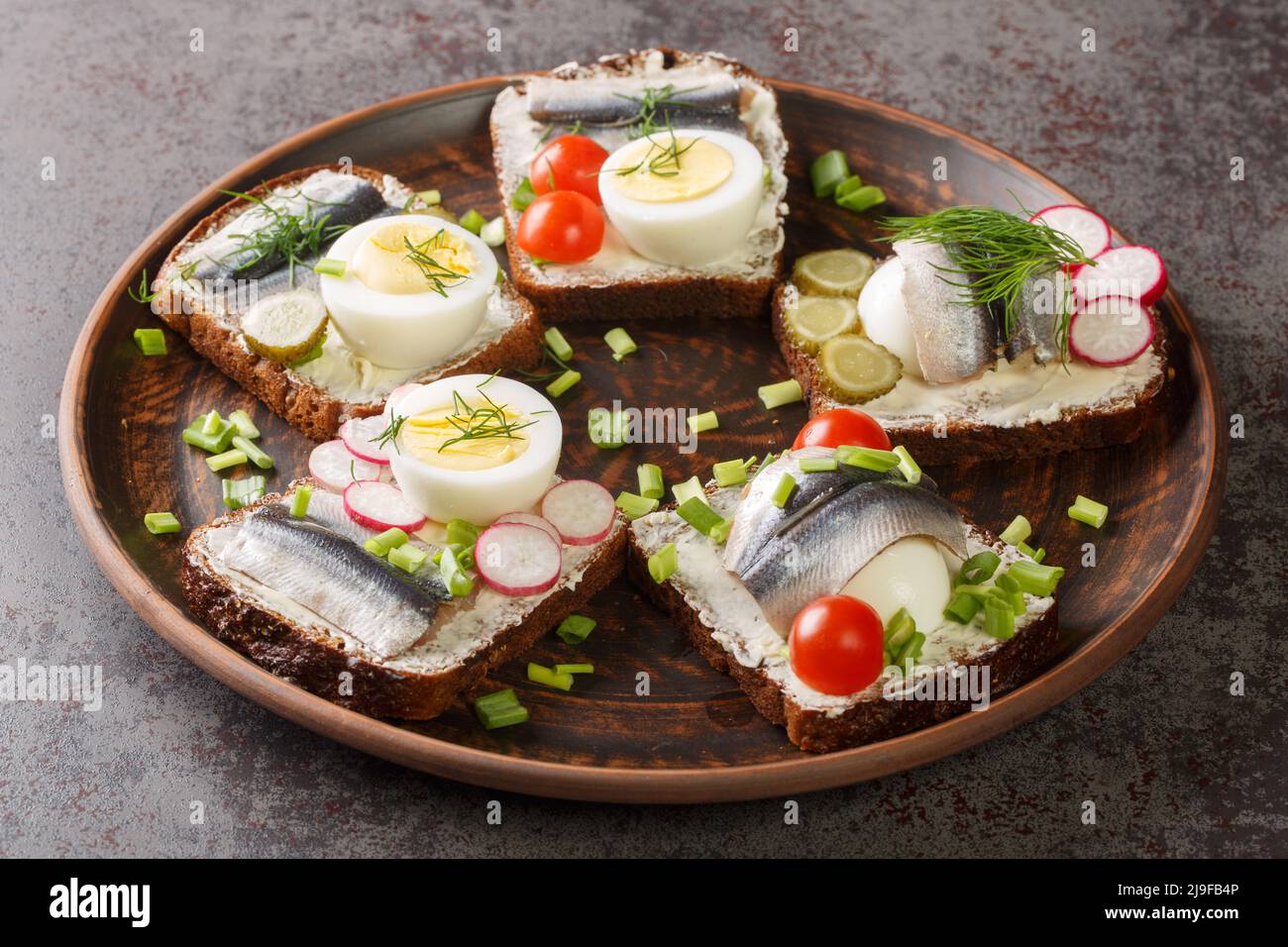 Estonian traditional delicacy kiluvoileib sandwich with fish, egg and