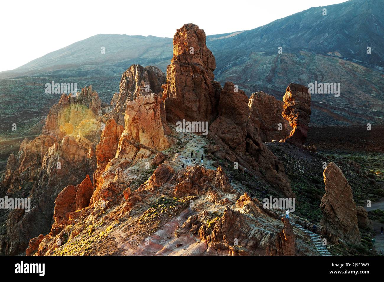 People climb the Roques de García rock formation in Teide National Park in Tenerife, Spain. Stock Photo