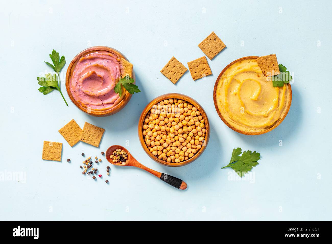 Various types of hummus in bowls. Hummus with spinach and beets Stock