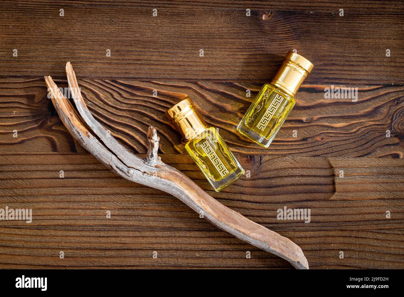 Arabian oud attar perfume essential oil in glass bottles, top view