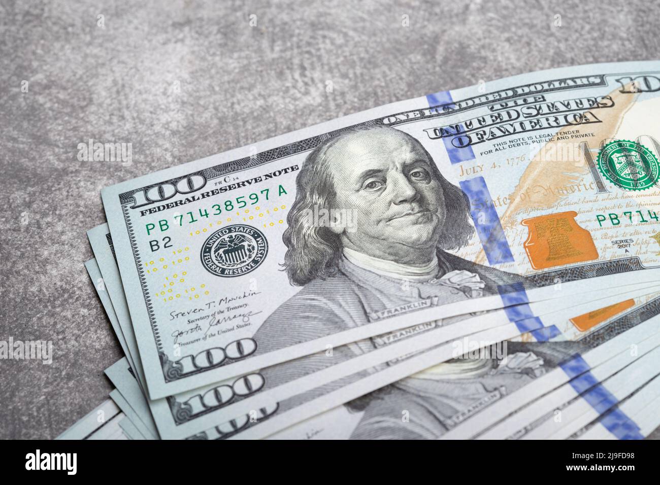 American dollar bills on grey stone background. Top view with copy space. Stock Photo