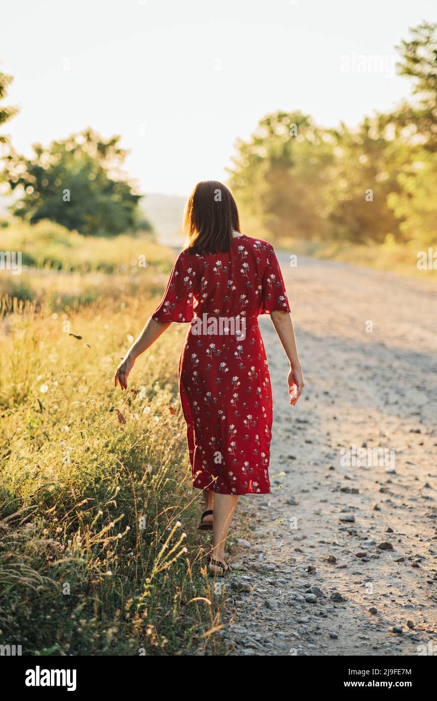 Connecting with nature benefits mental health. Nature Therapy Ecotherapy Helps Mental Health. Nature Impact Wellbeing. Woman in red dress enjoying Stock Photo